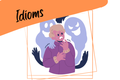a scared person shaking with ghosts behind him and the word "idioms"